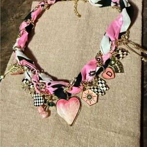 Brand new. Never worn. Handmade Pink and Gold Charm Necklace
